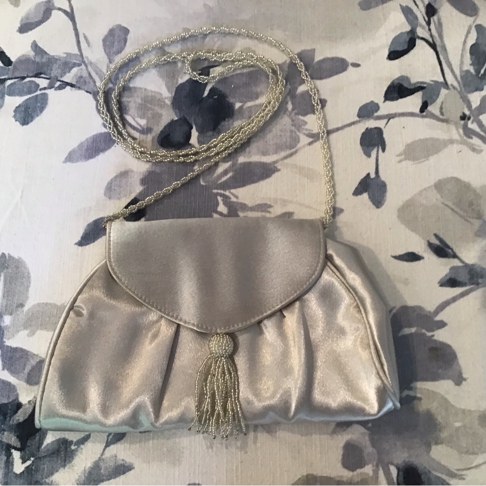 La Regale special occasion handbag. Silver satin body, beaded tassel and…
